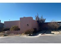 Pink tile exterior of single story home with landscaping and walkway at 644 Lacy Ln, Las Vegas, NV 89107