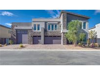 Contemporary home with stone accents and three-car garage at 8541 S Pioneer Way, Las Vegas, NV 89113