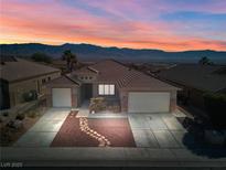 Beautiful single-story home featuring desert landscaping, a paver walkway, and a 2-car garage with mountain views at 1428 Chaparral Dr, Mesquite, NV 89027