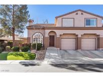 Two-story house with a two-car garage and landscaped front yard at 1605 Aspen Meadows Dr, Henderson, NV 89014