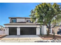 Two-story home showcasing a well-maintained lawn, black garage doors, and a neutral color scheme at 4871 Charlemagne Ave, Las Vegas, NV 89130