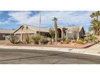 Charming single-story home featuring desert landscaping, a three-car garage, and a tile roof at 6308 Canyon Ridge Dr, Las Vegas, NV 89108