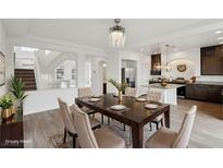 Bright dining room with hardwood floors and a spacious table, perfect for Gathering gatherings at 7646 Sandhaven St, Las Vegas, NV 89139