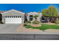 Single-story home with two-car garage, landscaped yard, and artificial turf at 10236 Rio De Thule Ln, Las Vegas, NV 89135