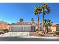 Single-story house with three-car garage, red tile roof, and desert landscaping at 10649 Bella Ordaz Way, Las Vegas, NV 89141