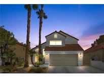 Charming two-story home featuring a tile roof, desert landscaping, and attached two-car garage at 144 Coventry Dr, Henderson, NV 89074