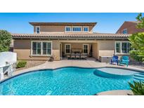 Gorgeous backyard boasts a refreshing pool and covered patio area for outdoor entertaining at 2920 Josephine Dr, Henderson, NV 89044