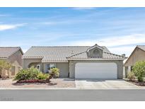 Single-story house with a two-car garage and well-manicured landscaping at 5915 Ablette Ave, Las Vegas, NV 89122