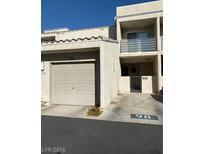 Two-story stucco condo building with attached garage and balcony at 6250 W Flamingo Rd # 98, Las Vegas, NV 89103