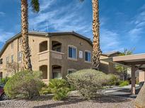 View of the attractive building featuring desert landscaping, palm trees, and covered parking at 8985 S Durango Dr # 2062, Las Vegas, NV 89113
