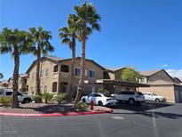 Exterior view of condo building with palm trees, covered parking, and well-maintained landscaping at 8985 S Durango Dr # 2062, Las Vegas, NV 89113