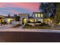Elegant two-story home featuring a landscaped front yard and a three car garage at 11554 Lampeter Ct, Las Vegas, NV 89138