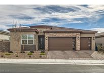 Single-story home with a brown three-car garage and landscaped front yard at 3395 Sleeping Hills Ave, Henderson, NV 89044