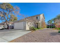 Two-story house with attached garage and landscaped yard at 586 Jackson Dr, Henderson, NV 89014