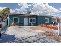 Charming one-story home featuring a quaint front yard with a white front door at 617 N Yale St, Las Vegas, NV 89107