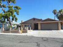 Charming single-story home with a well-maintained front yard, desert landscaping, and attached two-car garage at 6786 Grandola Dr, Las Vegas, NV 89103