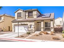 Charming two-story home featuring stucco, a tile roof, solar panels, and a two-car garage at 7553 Coral River Dr, Las Vegas, NV 89131