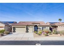 Charming single-story home featuring a tiled roof and a three-car garage with desert landscaping at 1008 New Creek Ave, Henderson, NV 89015
