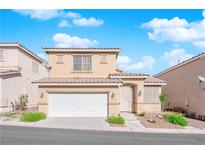 Charming two-story home featuring a two-car garage and desert landscaping against a backdrop of a blue sky and white clouds at 10412 Timber Canyon Ave, Las Vegas, NV 89129
