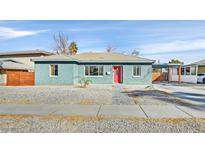 Charming single-story home featuring a red front door, covered parking, and low-maintenance landscaping at 1225 S 17Th St, Las Vegas, NV 89104