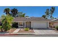 Charming single-story home featuring a well-manicured front yard and a two-car garage at 261 Grand Teton Dr, Henderson, NV 89074