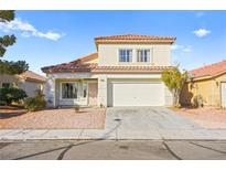Two-story house with Spanish tile roof, two-car garage, and desert landscaping at 4414 Scarlet Sea Ave, North Las Vegas, NV 89031