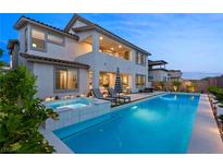 Luxury home with stunning pool, spa, lounge chairs, and outdoor living space at 472 Windstone Crest Ave, Las Vegas, NV 89138