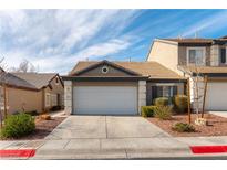 Charming single-Gathering home featuring a two-car garage, desert landscaping, and a well-maintained exterior at 523 Painted Cloud Pl, Las Vegas, NV 89144