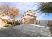 Two-story stucco home with a two-car garage and landscaped front yard on a sunny day at 7524 Schuders Ave, Las Vegas, NV 89178