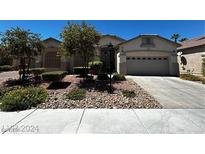 Charming single-story home with a well-manicured front yard and two-car garage at 7549 Evening Falls Dr Dr, Las Vegas, NV 89131