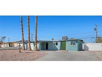 Charming single-story home with desert landscaping, palm trees, and a welcoming driveway at 1940 E Golden Arrow Dr, Las Vegas, NV 89169