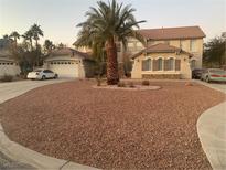 Charming two-story home features a large, well-maintained front yard with gravel and mature landscaping at 276 Glenridding St, Las Vegas, NV 89183