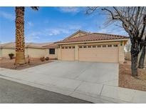 Single-story home with a three-car garage and desert landscaping at 5130 Stone Cove St, North Las Vegas, NV 89081
