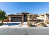 Charming single-story home featuring a well-manicured front yard and a two-car garage at 5805 Hannah Brook St, North Las Vegas, NV 89081