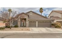 Charming single-story home featuring a well-manicured lawn and a spacious three-car garage at 830 Roaring Falls Ave, Henderson, NV 89052