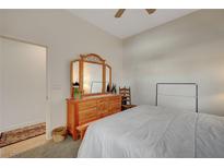 Bedroom with natural lighting, wood floors and dresser with decorative mirror at 9843 Wonderful Day Dr, Las Vegas, NV 89148