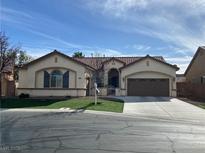 Charming single-story home with a well-manicured front yard and a two-car garage in a Gathering-friendly neighborhood at 9843 Wonderful Day Dr, Las Vegas, NV 89148