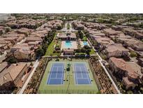 Aerial view of community with pool, tennis courts, and numerous homes at 11262 Corsica Mist Ave, Las Vegas, NV 89135