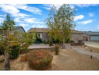 Single story home with landscaped front yard, walkway, and two-car garage at 250 Tonalea Ave, Henderson, NV 89015