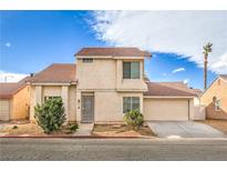 Charming two-story home featuring a tile roof, neutral stucco exterior and a well maintained front yard at 2727 Scotch Heather St, Las Vegas, NV 89142