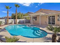 Inviting backyard pool with a spa, covered patio and lush landscaping, perfect for relaxation and entertainment at 283 Fancrest St, Henderson, NV 89052