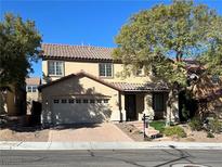 Charming two-story home featuring a tile roof, attached garage and inviting front entrance at 1163 Highbury Grove St, Henderson, NV 89002