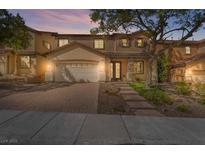 Charming two-story home featuring a well-manicured lawn, brick driveway, and inviting entrance at 1163 Highbury Grove St, Henderson, NV 89002