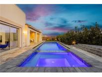 Inviting backyard pool and spa with elegant patio and landscaping at 11895 Skyline Arch Ct, Las Vegas, NV 89138