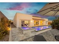 Inviting pool and spa with ambient lighting, complemented by a well-designed patio area at 11895 Skyline Arch Ct, Las Vegas, NV 89138