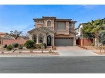 Stunning two-story home featuring stucco exterior, tile roof, arched windows, and a well-manicured front yard at 1381 Robard St, Las Vegas, NV 89135