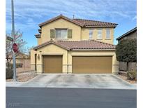 Two story home featuring a two car garage, neutral paint, and desert landscaping at 180 Plumpjack Ave, Henderson, NV 89002