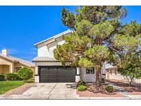 Inviting two-story home showcasing well-manicured landscaping and a two-car garage under a clear blue sky at 2133 Linden Tree St, Las Vegas, NV 89156