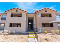 Condo building featuring accessible entrance, covered parking, and lush desert landscaping at 2451 N Rainbow Blvd # 2139, Las Vegas, NV 89108