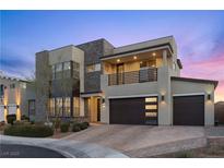 Modern two-story home with stacked stone accents, balcony, and a three-car garage at 3025 Merlesco Ave, Henderson, NV 89044